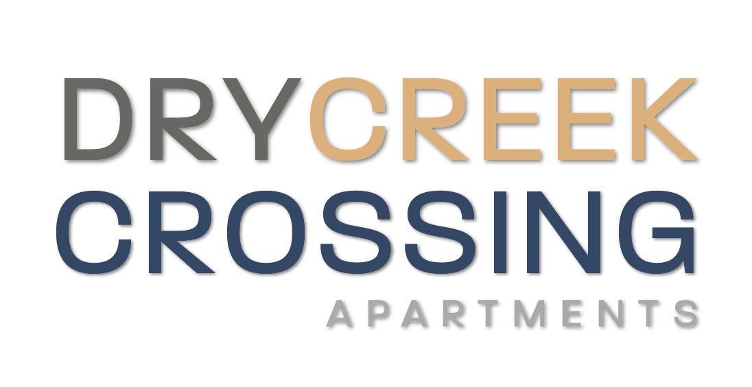 A black background with the words Dry Creek Crossing Apartments in gold and white.